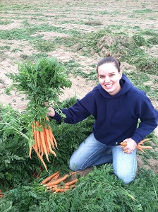 Kaylie holding fresh dug carrot